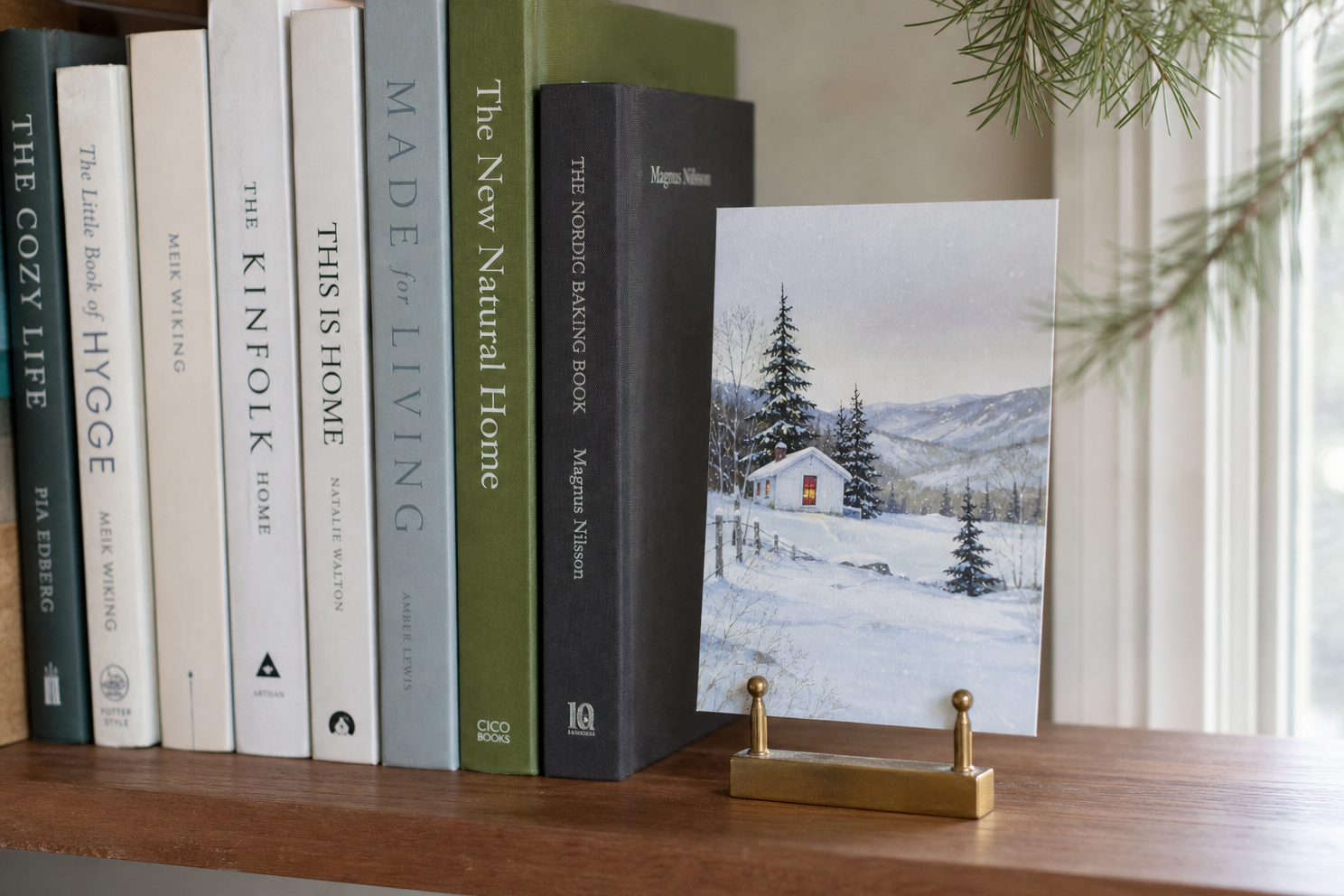 Holiday card in a small stand beside a row of books